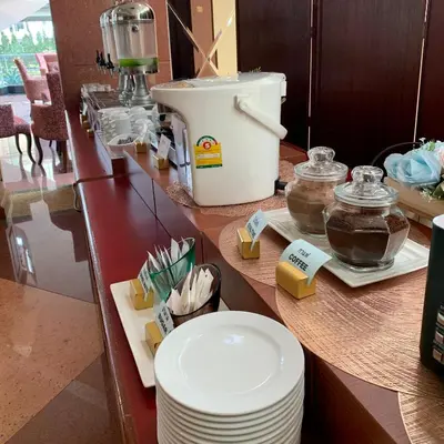 a counter with plates and a food processor on it at Grand Tower Inn Rama 6 in Bangkok