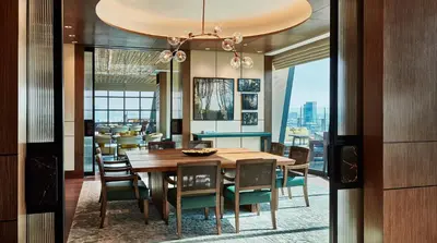 a dining room with a table and chairs at Hyatt Regency Bangkok Sukhumvit in Bangkok