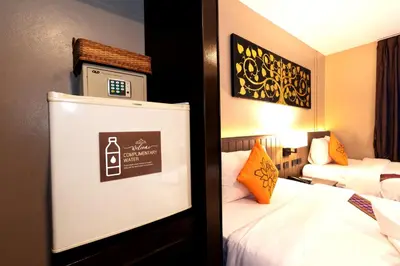 a hotel room with a bed and a sign on the wall at Baan Sukhumvit Soi 20 in Bangkok