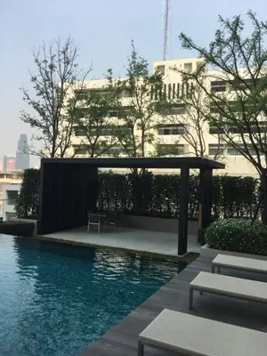 a swimming pool with a pergola next to a building at Bangkok view,Luxurious 1 Bedroom Sathon in Bangkok