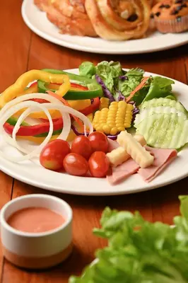 two plates of food with vegetables on a table at Hotel Mermaid Bangkok in Bangkok