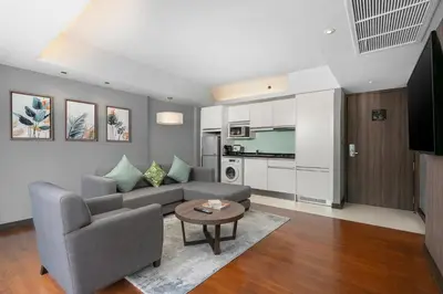 a living room with a couch and a table at Hotel Mermaid Bangkok in Bangkok