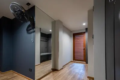 a room with a ceiling fan and a hallway at 19A Bangkok in Bangkok
