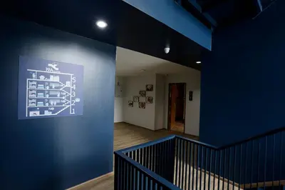 a blue wall in a hallway with a staircase at 19A Bangkok in Bangkok