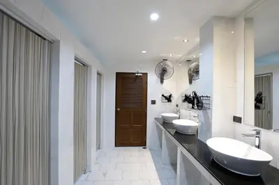 a bathroom with two sinks and two mirrors at 19A Bangkok in Bangkok