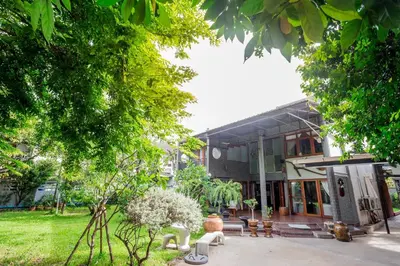a house with a garden in front of it at Narra House Sukhumvit58 in Bangkok