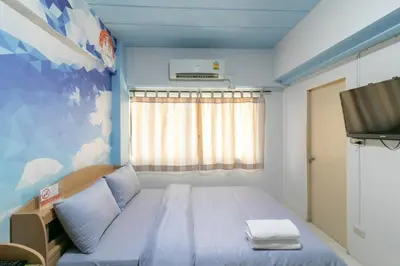 a small room with a bed and a tv at MS Mansion in Bangkok