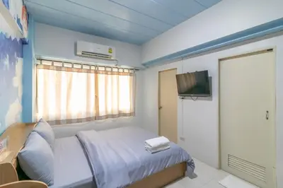 a hospital room with a bed and a television at MS Mansion in Bangkok