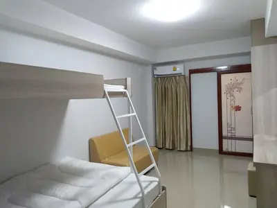 a bedroom with a bunk bed and a ladder at Roseate Bangkok Hotel in Bangkok