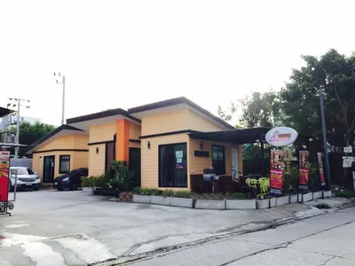 a fast food restaurant with a sign in a parking lot at Angie Resort at Sapan Mai in Bangkok