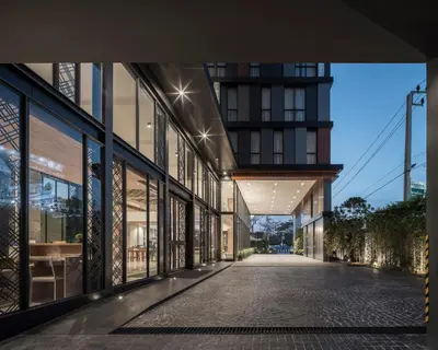 an empty street in a building with glass windows at Zayn Hotel Bangkok - Airport Link Access in Bangkok