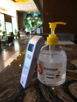 a bottle of soap and a soap dispenser on a counter at Grand Howard Hotel Bangkok in Bangkok