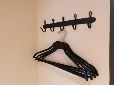 a black hanger hanging on a wall at Let's Zzz Bangkok in Bangkok