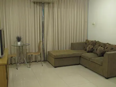 a living room with a couch and a table at 14 Resort in Bangkok