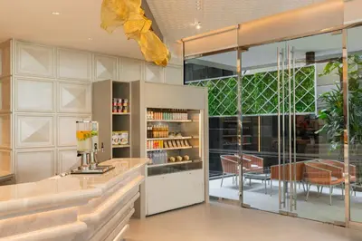 a kitchen with glass walls and a dining room at Hyatt Place Bangkok Sukhumvit 1 in Bangkok