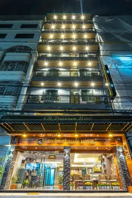 an apartment building with a restaurant in front of it at 4M Pratunam Hotel in Bangkok