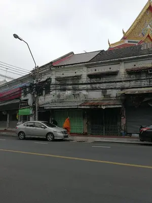 a car parked in front of a building on a street at Sip N' Camp in Bangkok