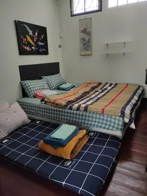 a large bed with towels on the floor in a room at Sip N' Camp in Bangkok