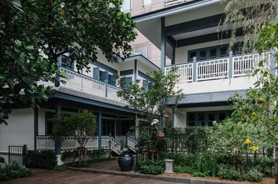 an exterior view of a building with a balcony at Baan Vajra in Bangkok