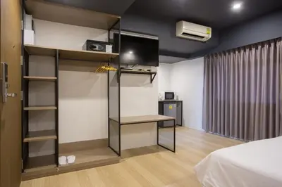 a room with a bed and a tv in a room at Toptel Thaphra - ท็อปเทล ท่าพระ in Bangkok