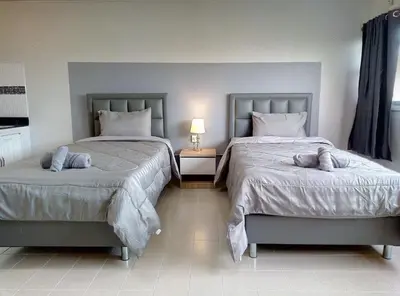 a bedroom with two beds with stuffed animals on them at Popular Condo Muangthong by Khun Eve in Nonthaburi