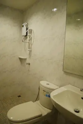 a bathroom with a toilet and a sink at The 92 Residence in Bangkok