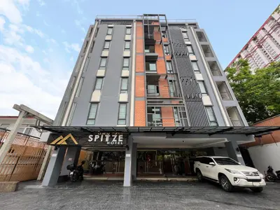 a white car parked in front of a building at Spittze Hotel Pratunam in Bangkok