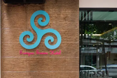 a sign on the side of a store at Samyan Serene Hotel in Bangkok