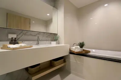 a bathroom with a sink and a mirror at Alix Bangkok Hotel in Bangkok