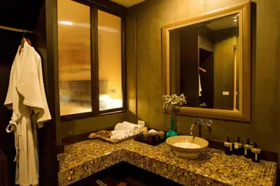 a bathroom with a sink and a mirror at Arun Residence in Bangkok