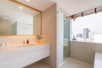 a bathroom with a sink and a mirror at VELA Dhi GLOW Pratunam in Bangkok