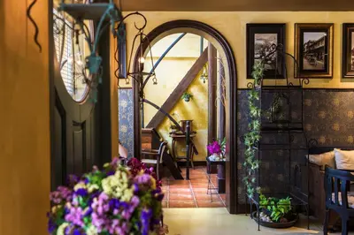 a hallway with an archway and flowers in a room at Old Capital Bike Inn - SHA Certified in Bangkok