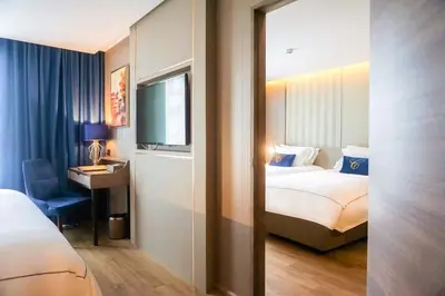 a hotel room with a bed and a television at GLOW Sukhumvit 5 in Bangkok