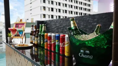 a group of bottles of beer in a bucket at GLOW Sukhumvit 5 in Bangkok