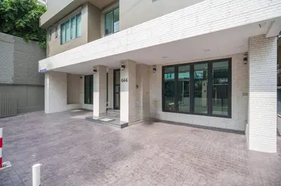 an empty parking lot in front of a building at Triple Four in Bangkok