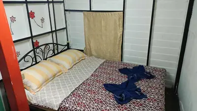 a bed with blue bows on top of it at New Phiman Riverview Guesthouse in Bangkok