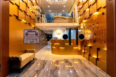 a lobby with a waiting room with a table and chairs at The LOL Elephant Hostel in Bangkok