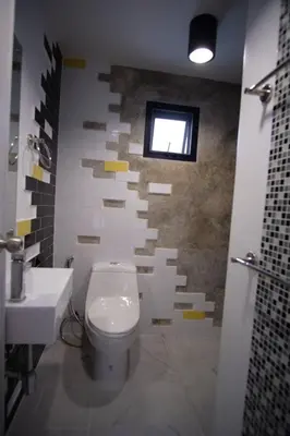 a bathroom with a white toilet and a sink at Ratch66 Huai Khwang MRT in Bangkok