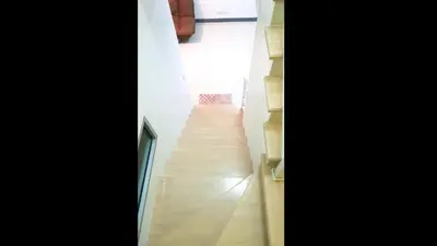 a stairway leading up to a hallway in a house at NIDO Guest House in Ban Bang Phang