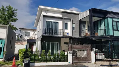a large house with a gate in front of it at NIDO Guest House in Ban Bang Phang