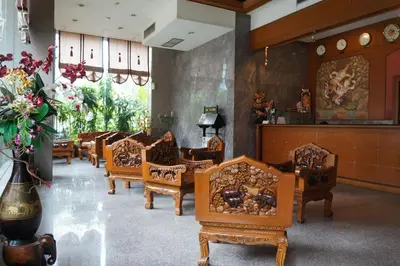 a row of chairs in a waiting room with flowers at Bangkok City Inn in Bangkok