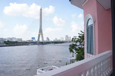 a balcony with a view of the eiffel tower at Hiranyakul House Riverside in Bangkok