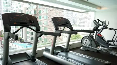 two exercise bikes in a gym next to a window at GM Serviced Apartment in Bangkok