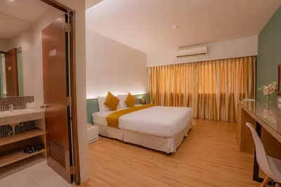 a hotel room with a bed and a large window at Peace Land Khaosan in Bangkok