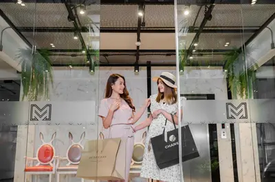 two women standing in front of a store window at Marwin Villa in Bangkok