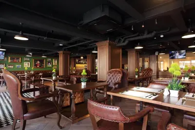 a dining room with wooden tables and chairs at Villa De Khaosan by Chillax in Bangkok