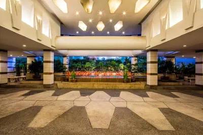 a lobby with a large building with a large window at Bangkok Palace Hotel in Bangkok