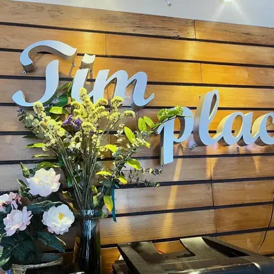a sign that says turn tables with flowers in a vase at Tim Place - BTS Phra Khanong in Bangkok