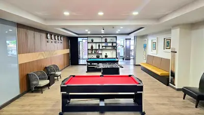 a billiard room with a pool table in it at Dynasty Grande Hotel in Bangkok