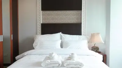 two towels sitting on top of a white bed at Today Tonight in Bangkok